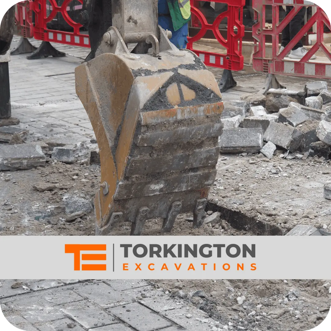 Mini digger carrying out excavation work in Stockport