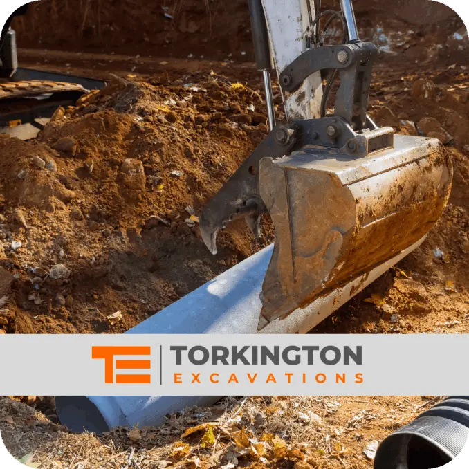 Groundworkers installing utility trench for water and electric services